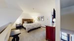 Loft style bedroom with 1 King bed, flat screen and attached bathroom